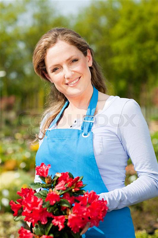 Woman holding red flowers, portrait, stock photo