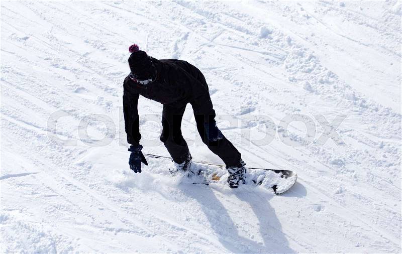 Snowboarder snowboarding in the snow in winter, stock photo