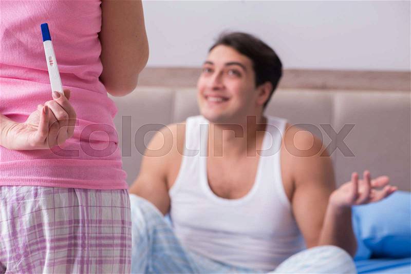 Young family with pregnancy test results, stock photo