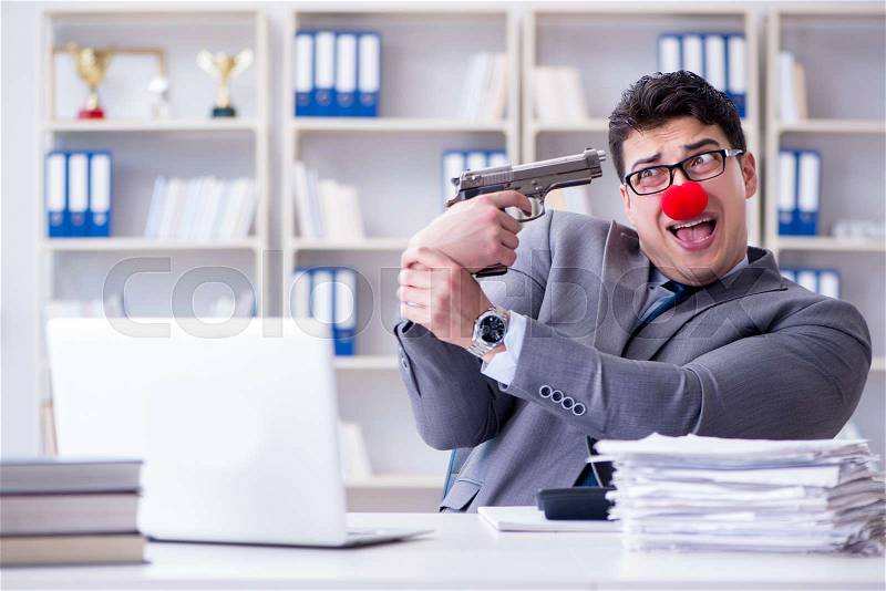 Clown businessman working in the office frustrated commiting suicide, stock photo