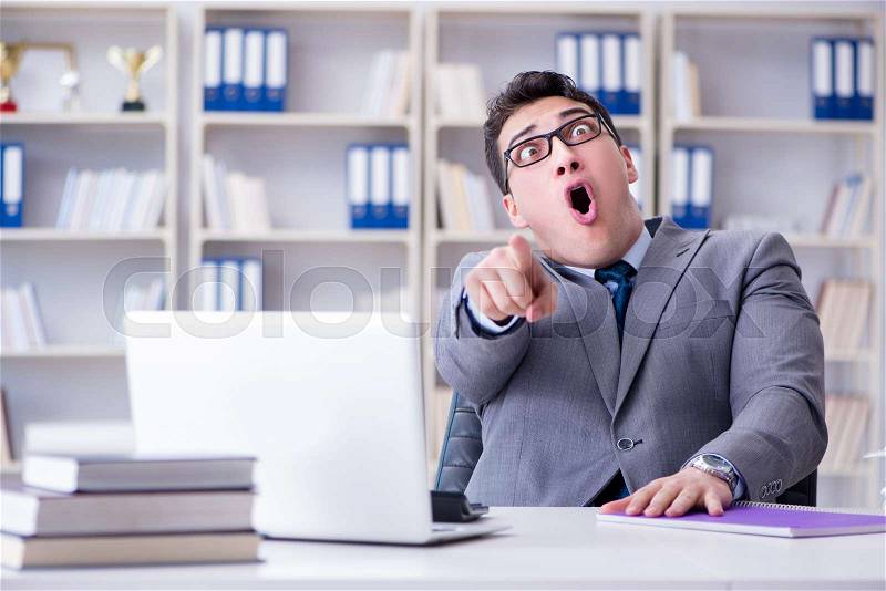 Funny businessman clown acting silly in the office, stock photo