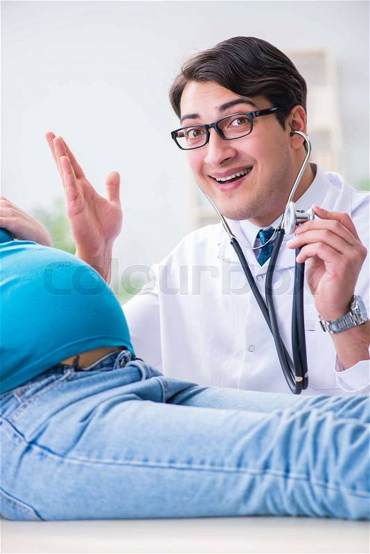 Pregnant woman visiting doctor in medical concept, stock photo