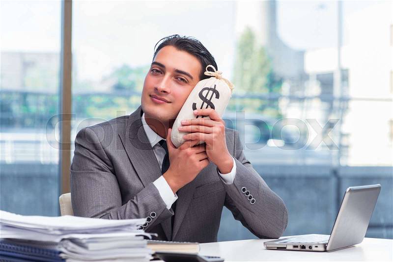 Businessman with money sack bag in office, stock photo