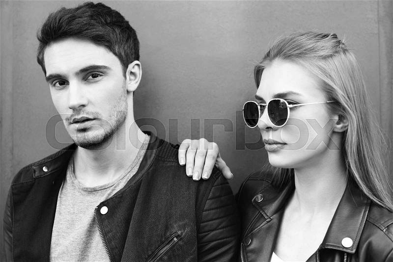 Black and white portrait of stylish young couple in love, stock photo