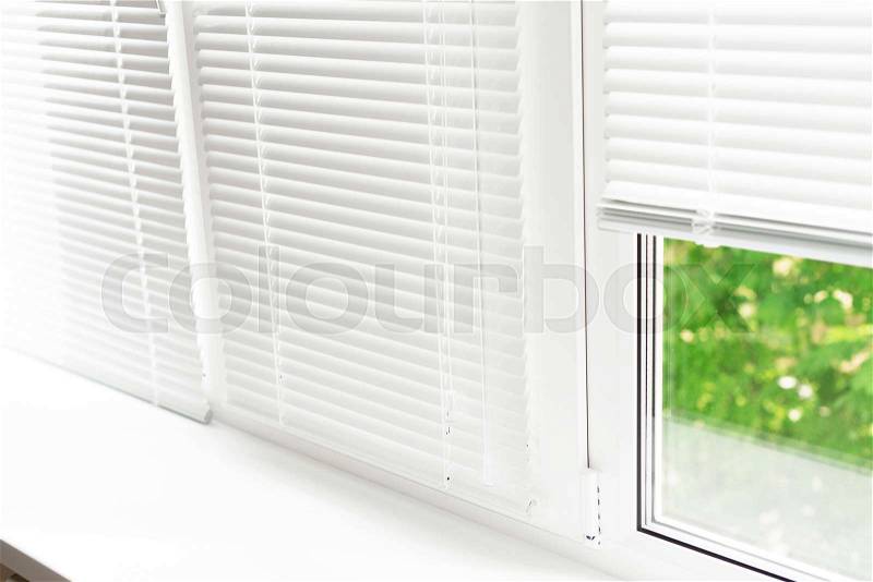 Windows with white venetian blinds, stock photo