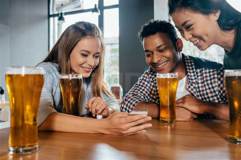 Happy young friends spending good time together in cafe, stock photo