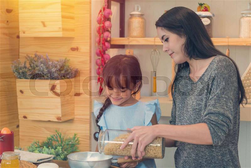 Happy kids with sister are cooking healthy meal in the kitchen, Happiness and people concept, stock photo