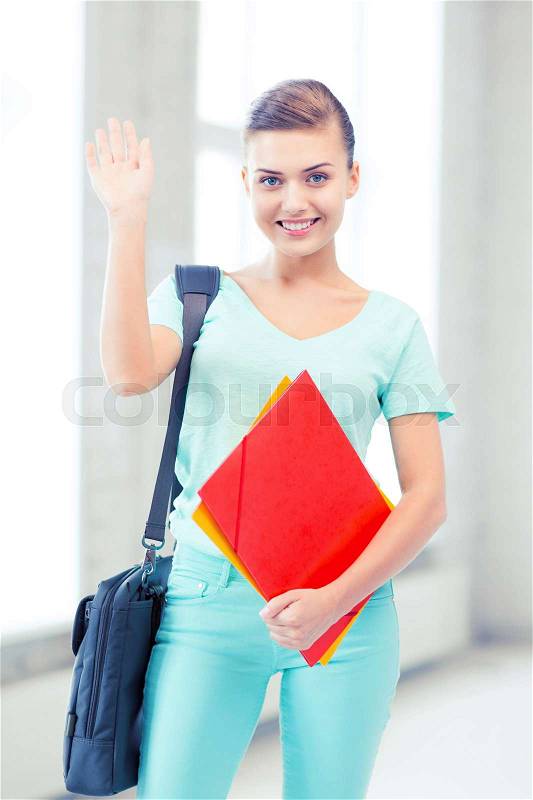Education concept - smiling student with folders and school bag in college, stock photo