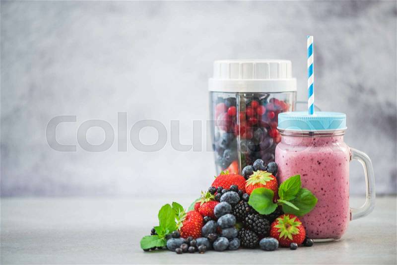 Blender ready for making berry smoothie and ingredients, stock photo