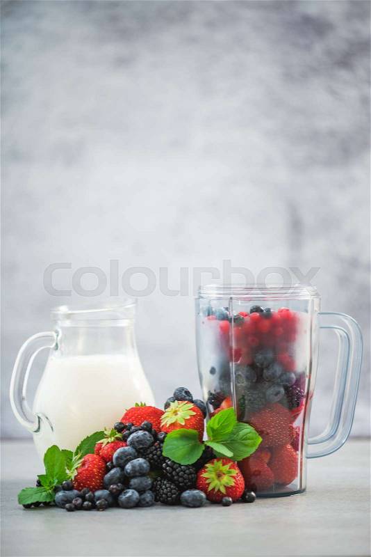 Blender with fruits and jar of milk for smoothie, stock photo