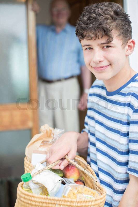 Portrait Of Teenage Boy Doing Shopping For Senior Man, stock photo
