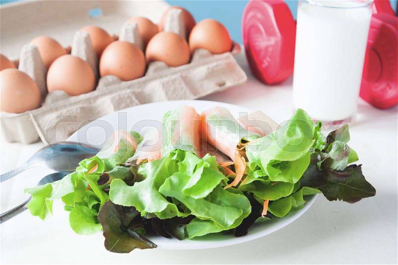 Fresh salad with egg and milk, Healthy menu with red dumbbell, Healthy lifestyle concept, stock photo