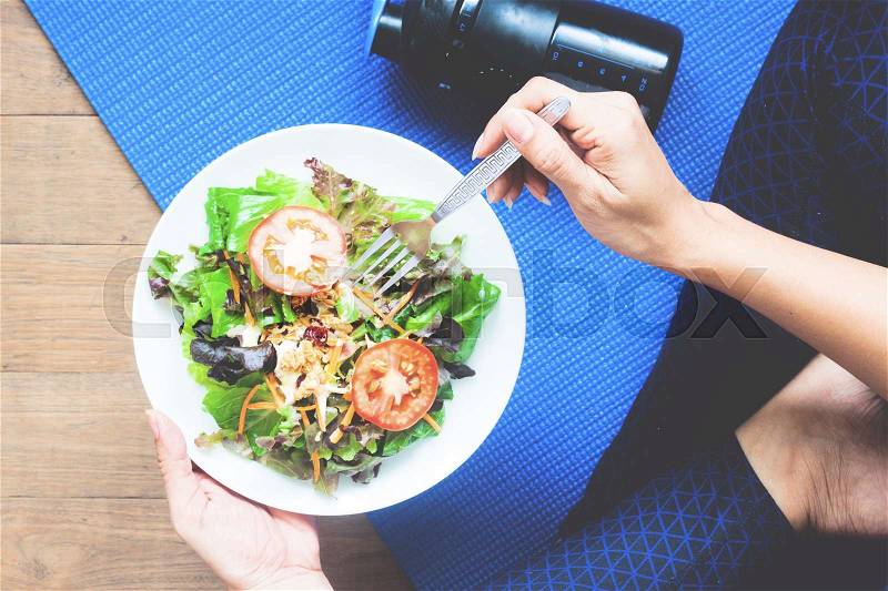 Yoga woman eating fresh salad, Fitness and Healthy concept, stock photo