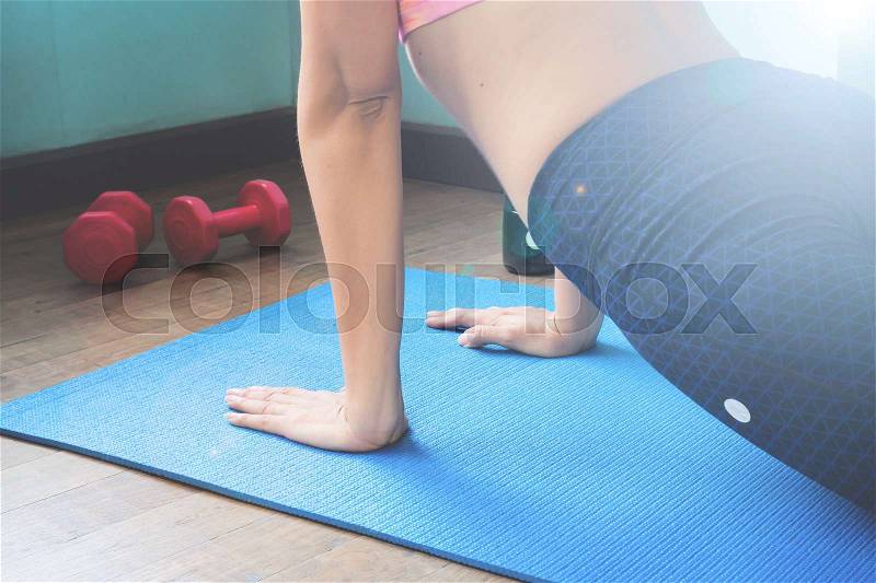 Woman doing yoga at home, Selective focus on hands, Healthy and gym workout, stock photo