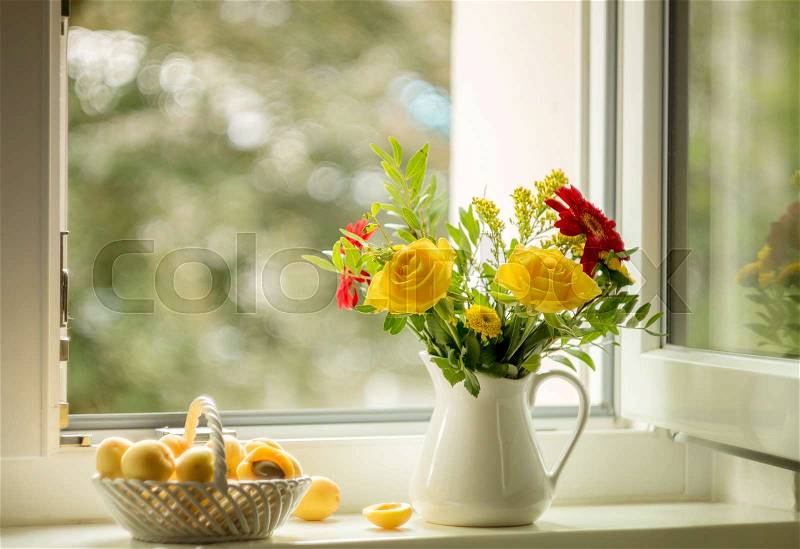Summer still life with roses and apricots on the windowsill, stock photo