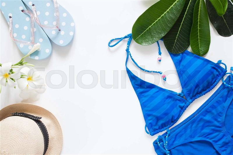 Overhead view of summer concept with blue stripe bikini, sandal, hat, iced drink and plumeria flower, Isolated on white background, stock photo