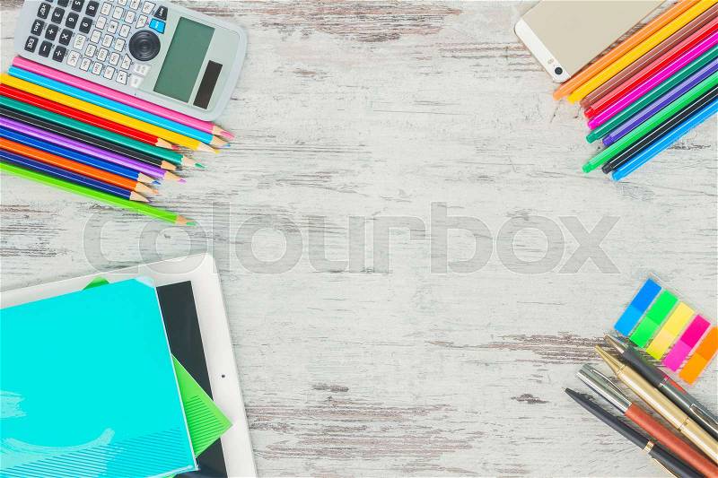 Back to school top view frame with school supplies on wooden table, stock photo