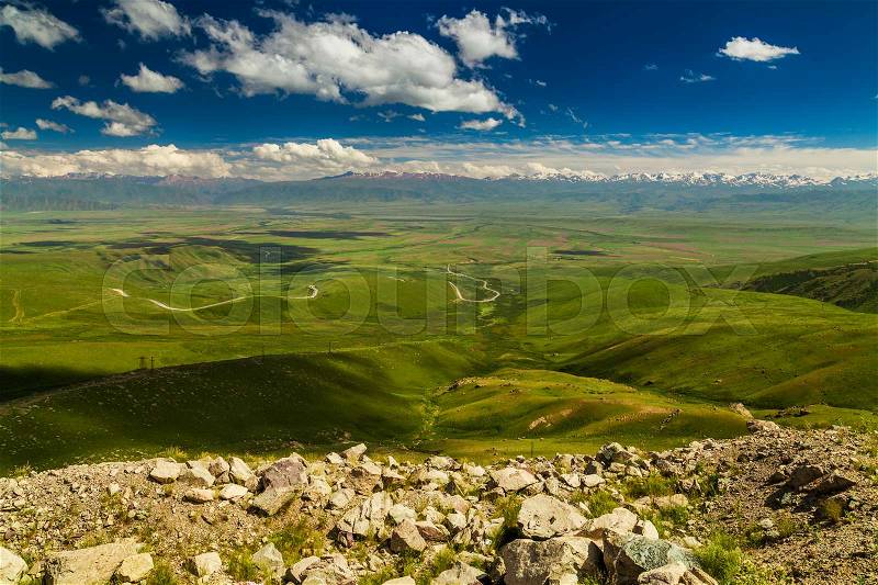 View from pass to green valley and the mountains. Kyrgyzstan, stock photo
