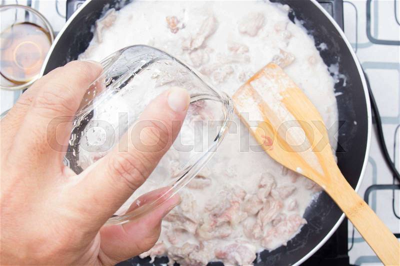 Chef pouring water fro cooking green curry / cooking green curry concept, stock photo