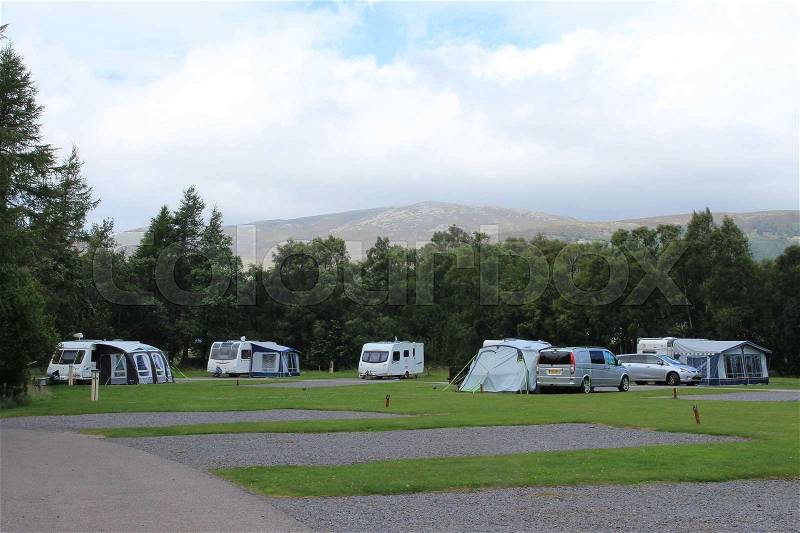 Blue sky with clouds and a camping site at the Highlands at the village Braemar in Scotland in the summer, stock photo