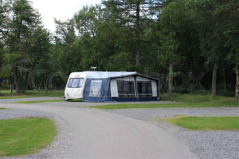 Caravan wit a tent on the camping site at the Highlands at the village Braemar in Scotland in the summer, stock photo