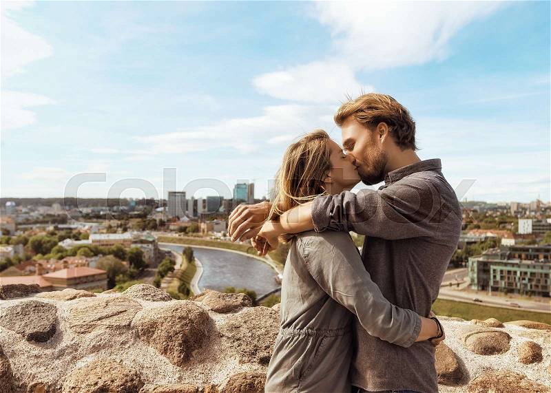 Young couple kissing in front of city skyline. Romantic concept , stock photo