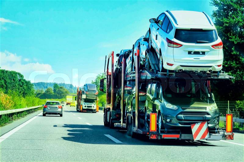 Car transporter truck on the road, in Switzerland, stock photo