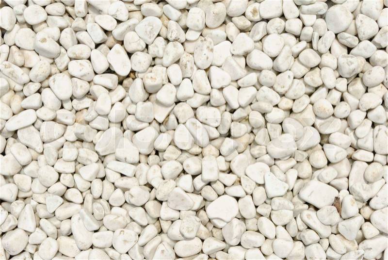 Small naturally polished white rock pebbles background, stock photo