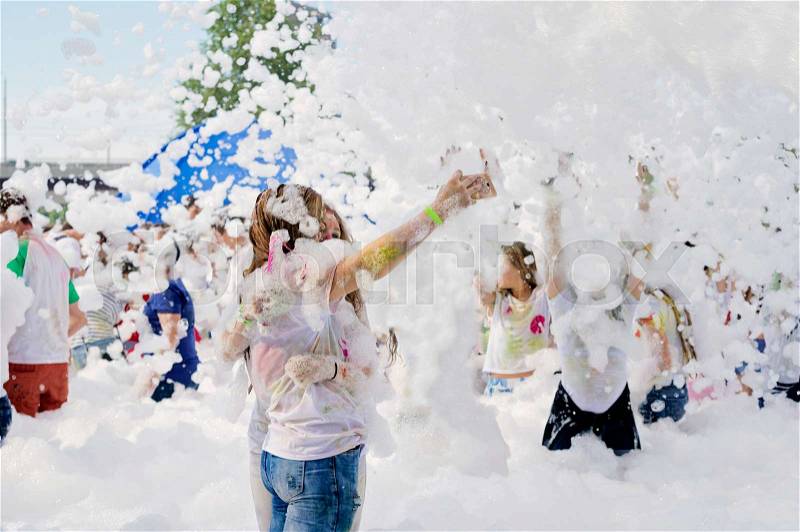 Young people in the foam. Outdoor foam party, stock photo