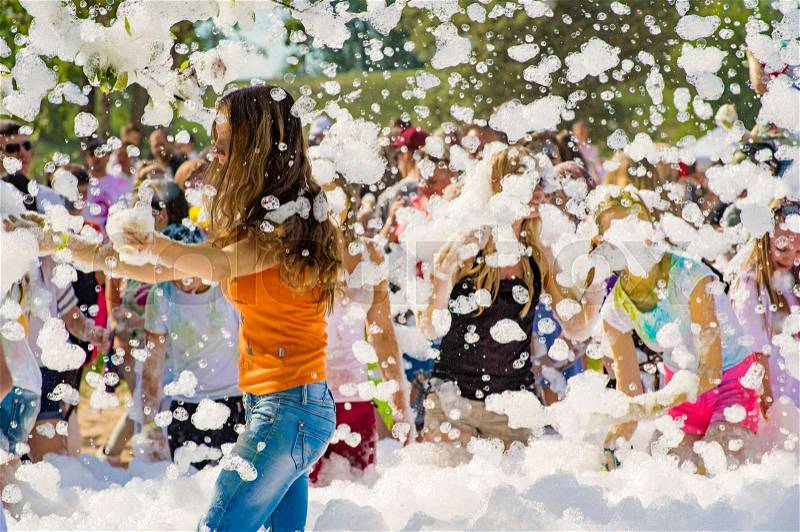 Young people in the foam. Outdoor foam party, stock photo