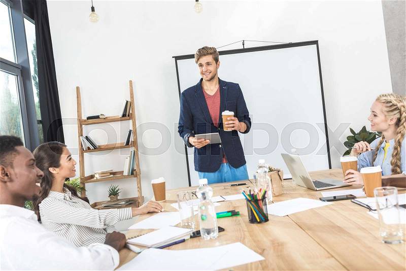 Multicultural business team discussing new strategy and ideas at meeting in office, stock photo