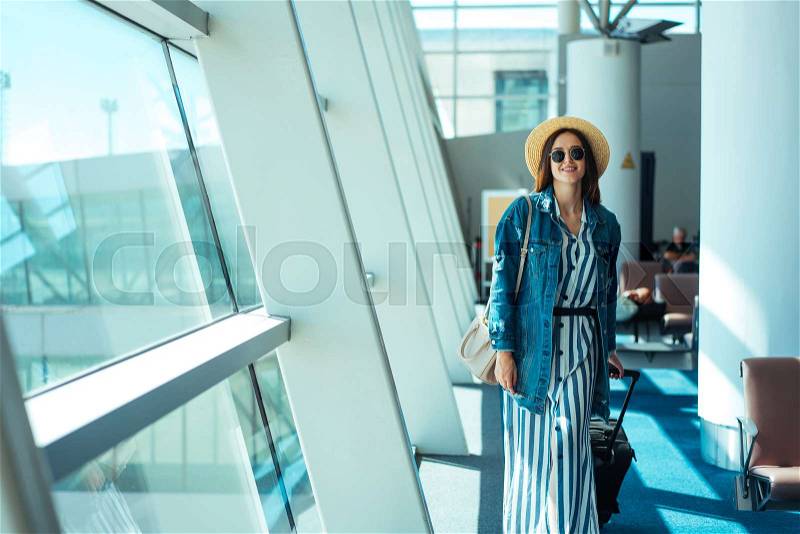 Woman go travel with suit case at airport, stock photo