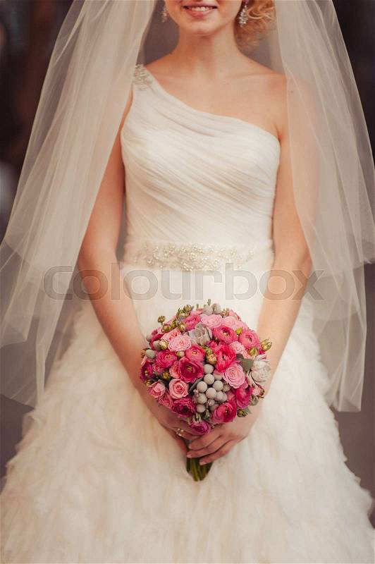 Bride holding big wedding bouquet on wedding ceremony, stock photo