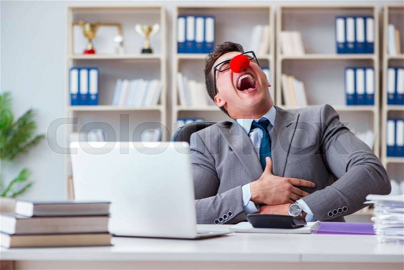 Clown businessman having fun in the office, stock photo