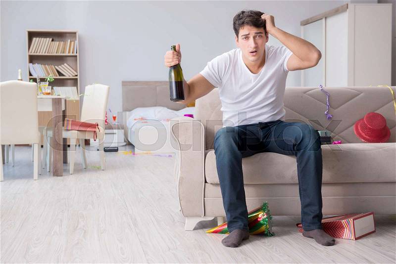 Young man after the wild Christmas party, stock photo