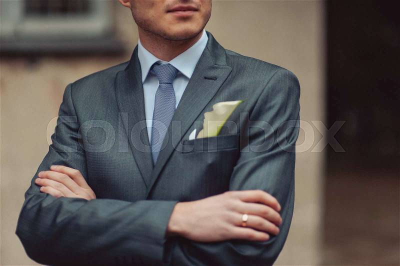 The groom puts on his tie. A business man is dressing a tie, stock photo