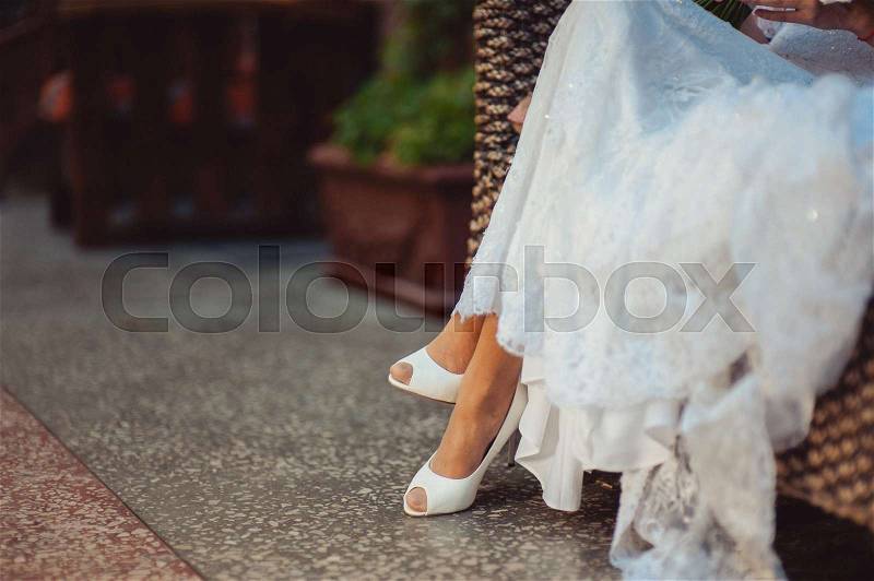 Feet of the groom and bride on the walk, stock photo