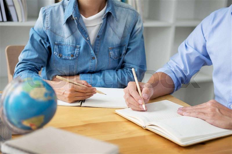 Young students campus helps friend catching up and learning tutoring. People, learning, education and school concept, stock photo