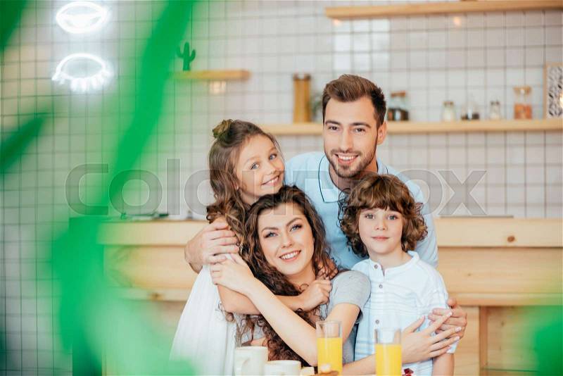 Group portrait beautiful young family in modern cafe, stock photo