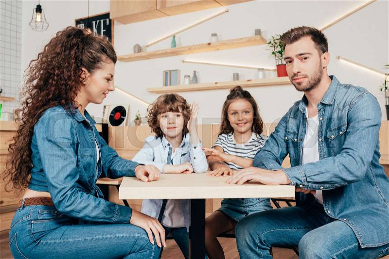 Beautiful young family in cafe waiting for order, stock photo