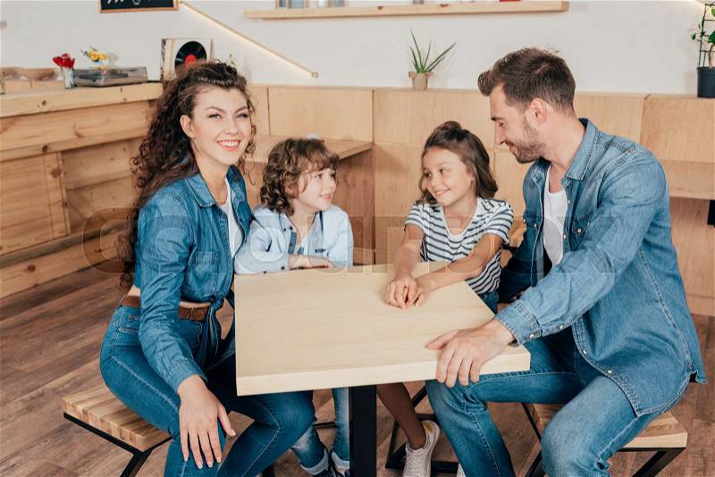 Beautiful young family in cafe waiting for order, stock photo