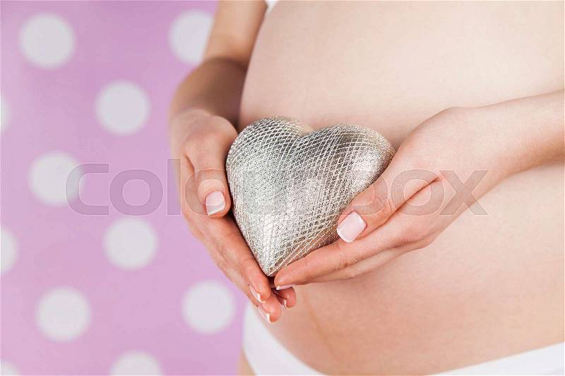 Close up of a cute pregnant belly, Heart, stock photo