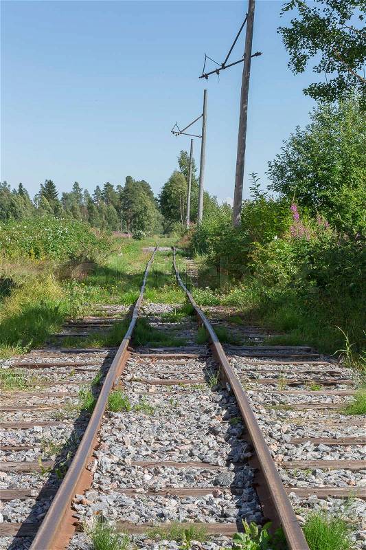 Old Railroad Tracks in nature with a blue sky, stock photo