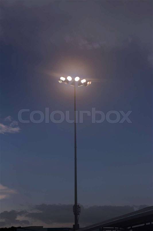 Spot light pole against white cloud and blue sky ; , stock photo