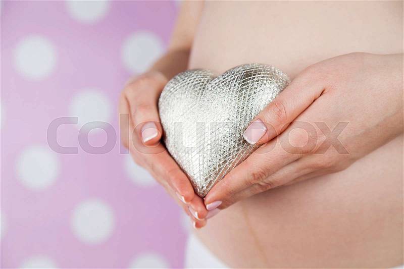 Close up of a cute pregnant belly, Heart, stock photo