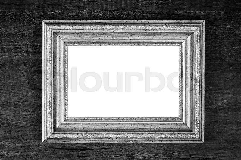Black picture frame on black wood wall, stock photo