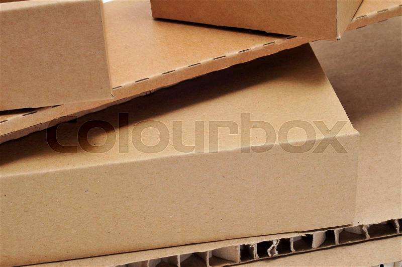 Closeup of some brown cardboard boxes and some pieces of corrugated cardboard, stock photo