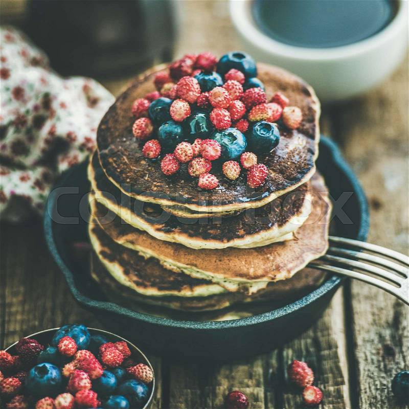 Breakfast with pancakes with forest berries and honey, square crop, stock photo