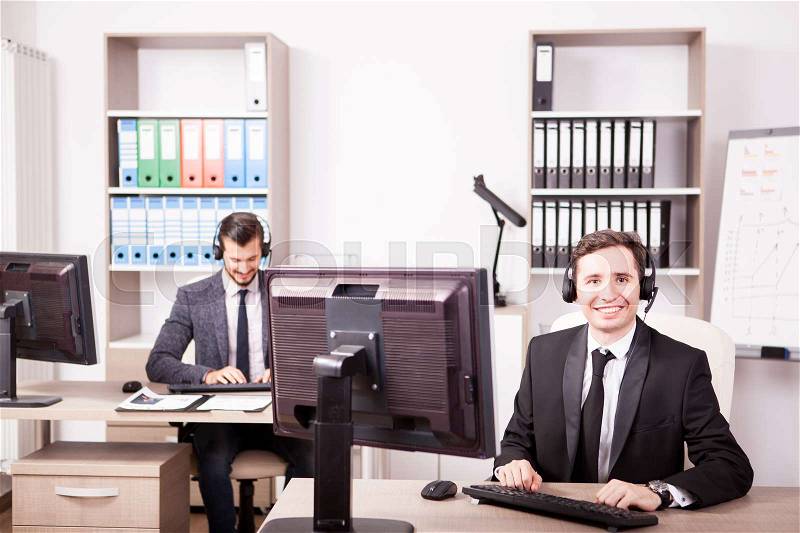 Smiling Customer service support working in office. Professional online and telephone assistant support, stock photo
