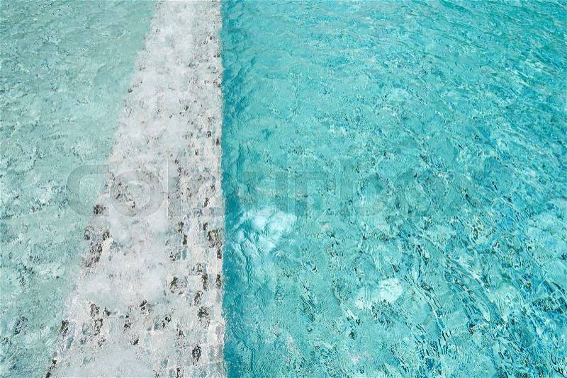 Light blue swimming pool rippled water for background, stock photo